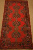 Turkish red ground rug, stylised decoration,