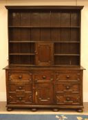 18th century country oak dresser, seven drawers and cupboard with geometric moulding,