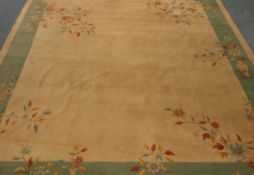 Large Indian rug, beige ground with green border,