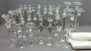 Quantity of glass candlesticks and candelabras and a quantity of white candles Condition