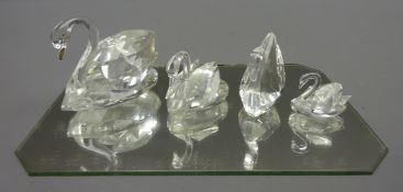 Four Swarovski crystal swans, various sizes, all boxed,