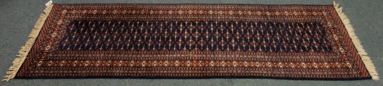 Hand knotted, Persian pattern runner, blue ground with hooked medallion field W97cm,