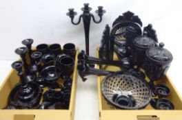 Quantity of black glassware including; candlesticks, vanity mirror,