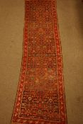 Persian runner rug, decorated with Herati motif, red border,