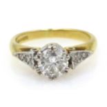 Single stone diamond gold ring, with diamond set shoulders,