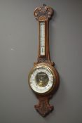 Early 20th century oak cased aneroid barometer with visible mechanism, enamel ceramic dial,