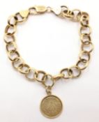 9ct gold cable link bracelet stamped 375, with medallion approx 15.