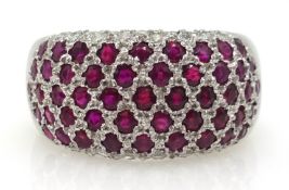 18ct gold ruby and diamond bombe ring with diamond edging,