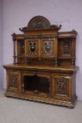 Edwardian oak sideboard, carved pediment with winged cherub, stepped projecting cornice,