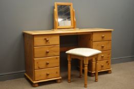 Polished pine twin pedestal dressing table fitted with eight drawers, swing mirror and stool,