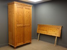 Pine double wardrobe enclosed by panelled doors (W107cm, H196cm, D56cm),