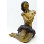 Cast metal figure of a seated semi nude woman,