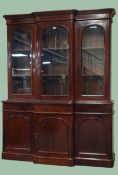 Victorian mahogany library bookcase, projecting cornice, three doors with arched beveled glazing,