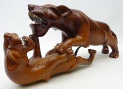 Hardwood group of a lion and lioness carved from the solid,