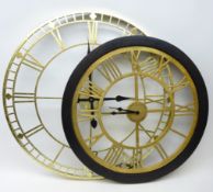 Two large battery operated wall hanging clocks, the dials with Roman numerals,