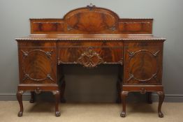 Early 20th century figured mahogany inverted break front sideboard with raised and carved back,