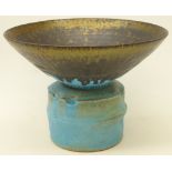 Studio pottery footed vase decorated with turquoise and bronzed manganese rim,