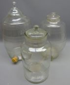 Two graduated clear glass spirit barrels, each with cut decoration and dispensing aperture,
