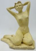 Cream painted figure of a seated nude, signed 'Howes April 56',