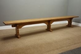 'Mouseman' oak trestle bench, adzed top on three shaped supports, by Robert Thompson of Kilburn,