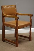 'Lizardman' carver armchair upholstered in tan leather with stud detail, by Martin Dutton of Huby,
