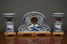 Early 20th century ceramic clock garniture, with enamel marbled effect finish,