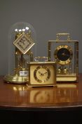 Late 20th century 'Kundo' anniversary torsion clock with lozenge shaped dial, under dome (H29cm),