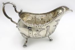 George III Irish silver sauce boat, embossed rustic scenes,