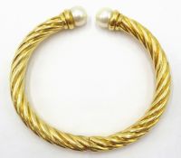 Gold rope twist hinged bangle, the open ends with pearl terminals hallmarked 18ct approx 25.