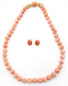 Coral bead necklace and pair of 18ct gold coral clip on ear-rings stamped 750 Condition