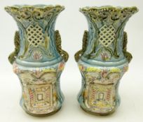 Pair of Victorian blue glazed, two handled vases with moulded, pierced and painted decoration,