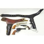 Two replica American Wild West revolvers in leather holster belts and another replica revolver (3)