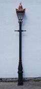 Victorian style cast iron street lamp post with copper and glass lantern top,