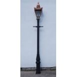 Victorian style cast iron street lamp post with copper and glass lantern top,