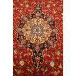 Persian Meshed red ground rug carpet, pointed medallion with rosette,