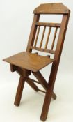 Child's or doll's mahogany stick back folding chair, with shaped bar back and X shaped frame,