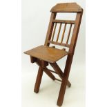 Child's or doll's mahogany stick back folding chair, with shaped bar back and X shaped frame,