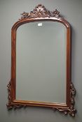 Mahogany framed bevel edged wall mirror, carved foliate pediment and brackets, W79cm,