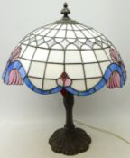 Tiffany style table lamp with leaded glass shade and moulded cast metal base,