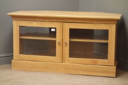 Oak finish television stand, two glazed doors enclosing one shelf, plinth base, W115cm, H61cm,