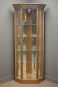 Oak finish illuminated corner display cabinet, enclosing four glass shelves,