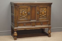 18th century style carved cupboard, two doors with coat of arms carvings above two drawers,