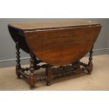 Early 20th century oak drop leaf table, gate action base, bobbin turned supports and stretchers,