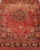 Persian Kashan red ground rug, floral and urn repeating border, central medallion,