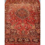 Persian Kashan red ground rug, floral and urn repeating border, central medallion,