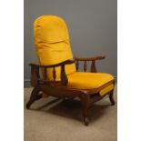 Early 20th century oak reclining armchair, upholstered in mustard velvet, raising arm rests,