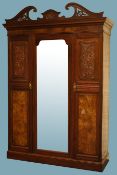 Large Edwardian walnut wardrobe, swan neck pediment with carvings, projecting cornice,