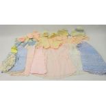 1950's children's clothing including knitted cardigans, bonnets, shoes, embroidered cotton dresses,