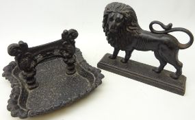 Cast iron boot scraper and cast iron fireside figure of a lion,