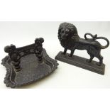 Cast iron boot scraper and cast iron fireside figure of a lion,